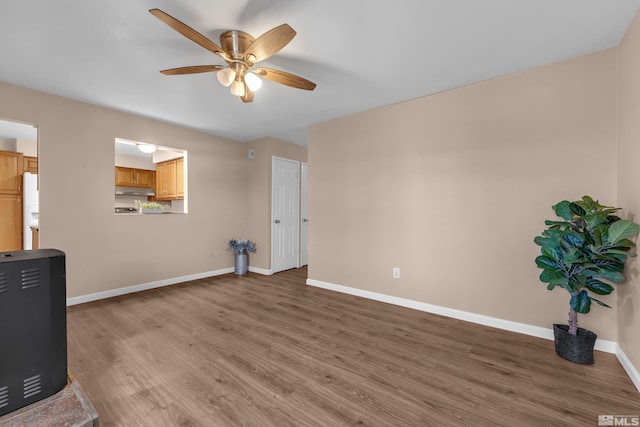 unfurnished living room featuring ceiling fan and wood-type flooring