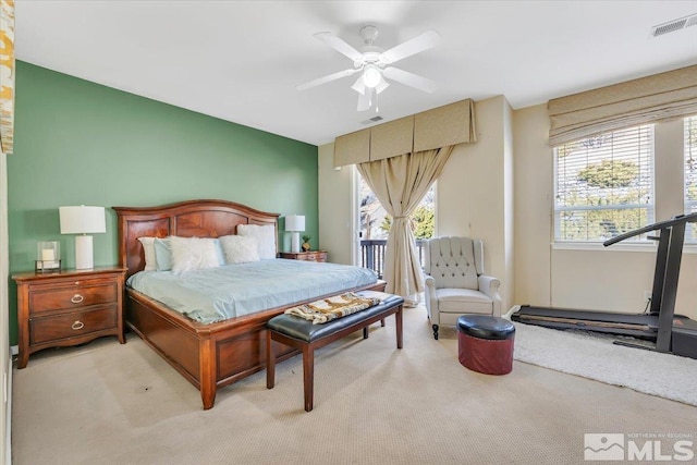 carpeted bedroom with multiple windows and ceiling fan