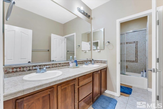 bathroom with shower / bath combination with glass door, vanity, and tile patterned flooring