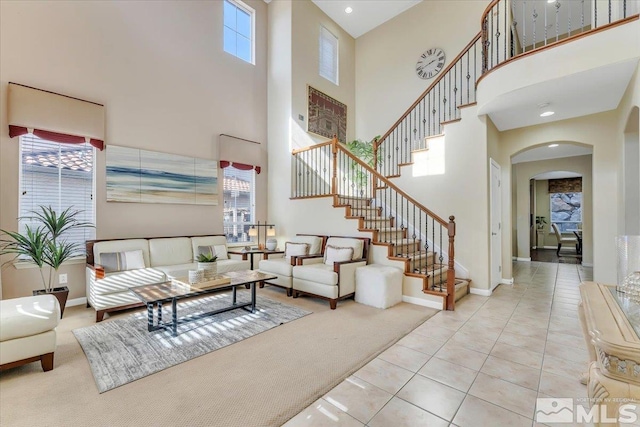 interior space featuring light tile patterned flooring and a high ceiling