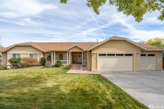 ranch-style home featuring covered porch, a garage, and a front yard