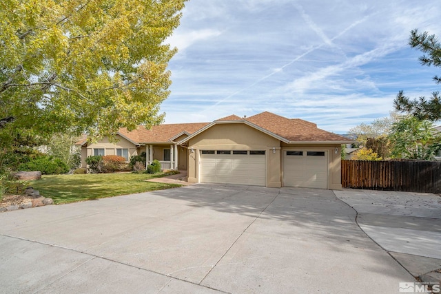 ranch-style home featuring a front yard and a garage