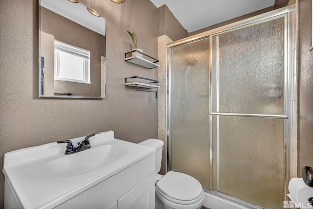 bathroom featuring toilet, an enclosed shower, and vanity