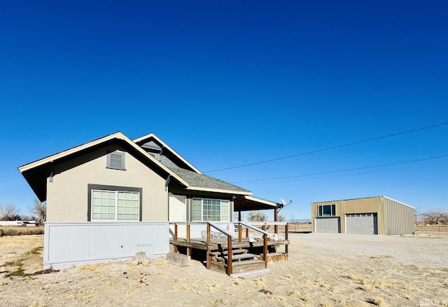 view of front of house with a garage and an outdoor structure