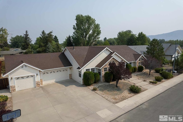 single story home with a mountain view and a garage