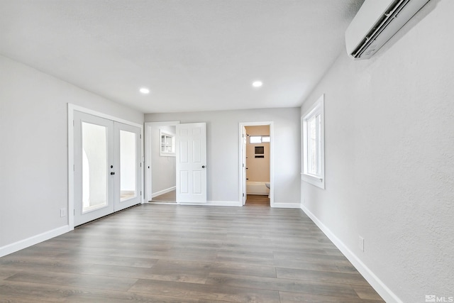 foyer with french doors, dark hardwood / wood-style flooring, and an AC wall unit