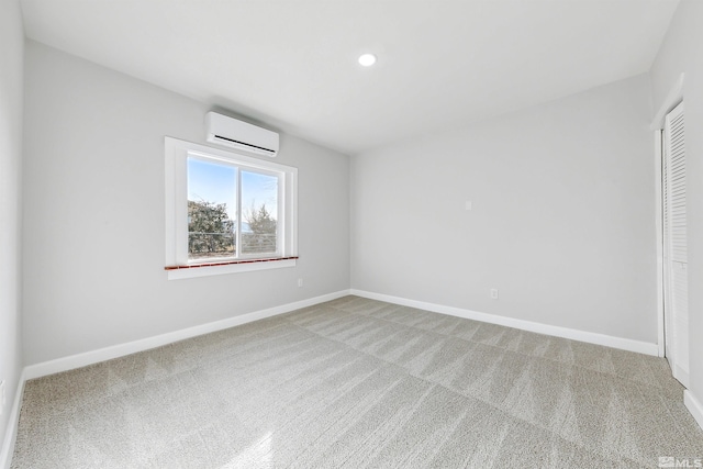 carpeted empty room featuring a wall unit AC