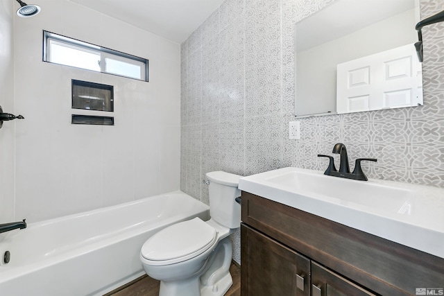 full bathroom with hardwood / wood-style floors, vanity, bathing tub / shower combination, toilet, and tasteful backsplash