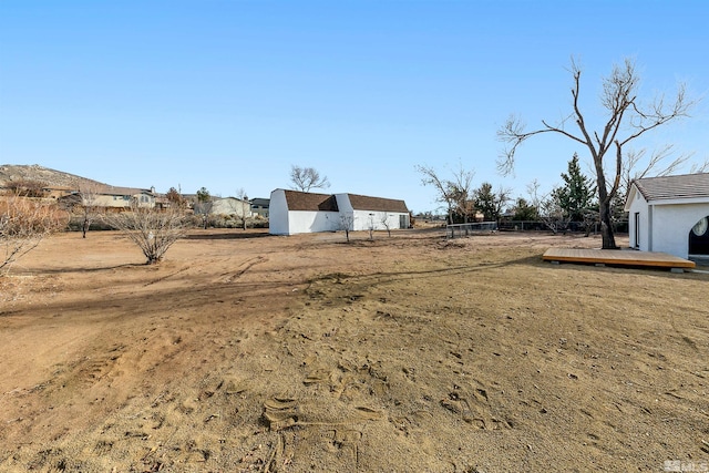 view of yard with a wooden deck and an outbuilding