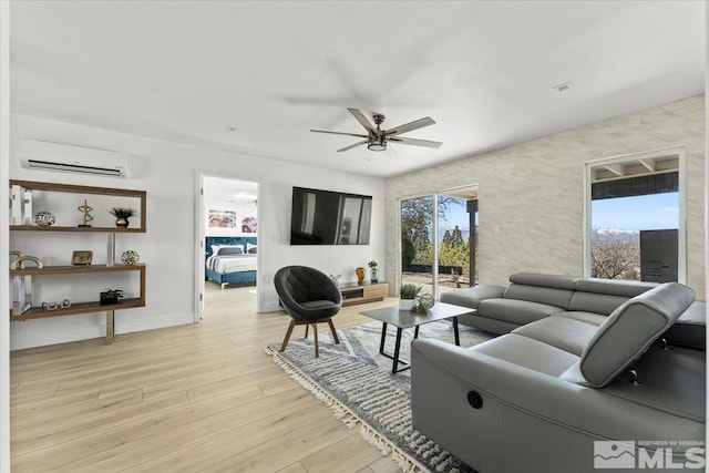 living room with a wall mounted AC, ceiling fan, and light wood-type flooring