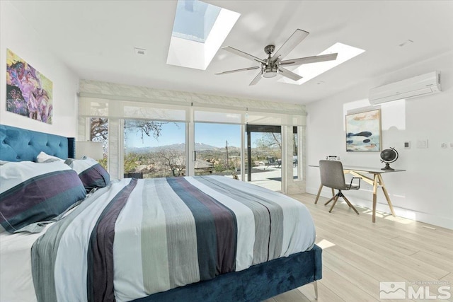 bedroom featuring ceiling fan, light hardwood / wood-style floors, access to exterior, and an AC wall unit