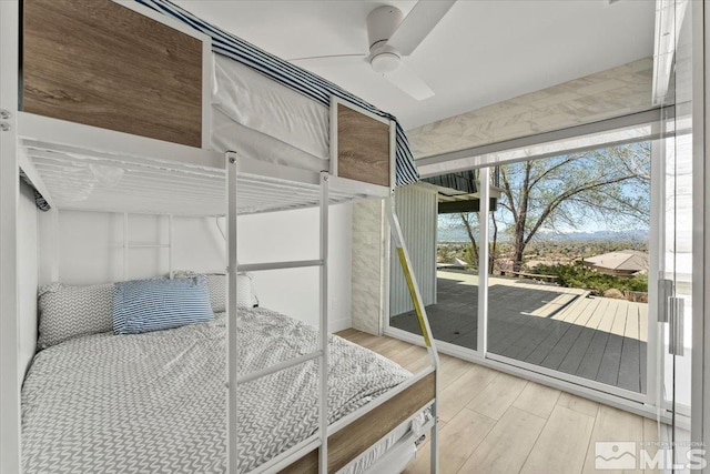 bedroom with access to outside, ceiling fan, and wood-type flooring