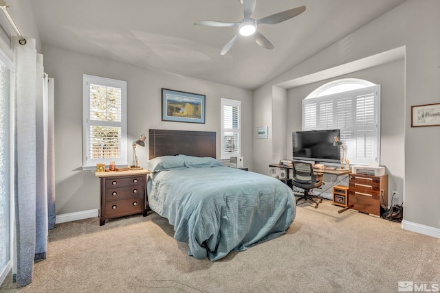 carpeted bedroom with vaulted ceiling and ceiling fan