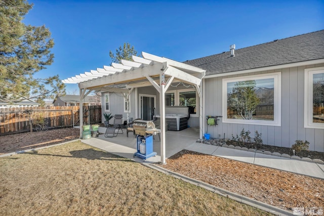 rear view of property featuring a patio, a pergola, and a hot tub