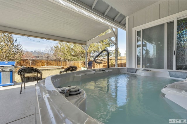 view of pool with a hot tub