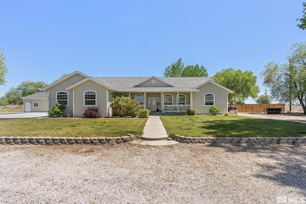 single story home with covered porch and a front yard