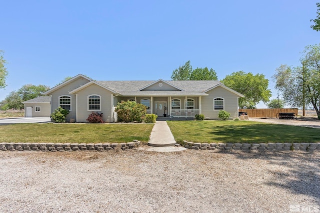 single story home with covered porch and a front yard