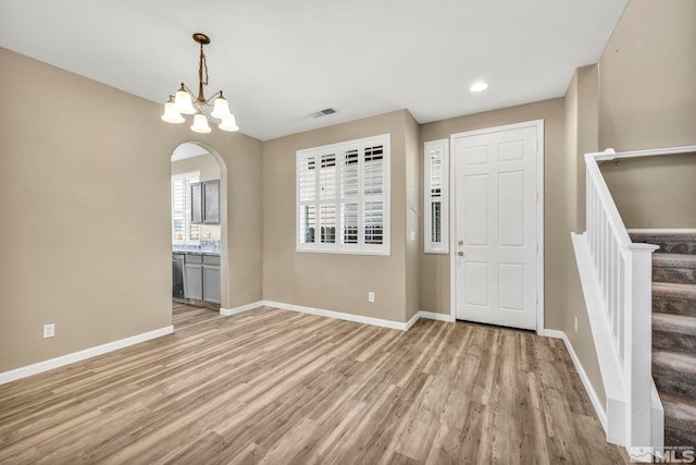 foyer featuring light hardwood / wood-style flooring and a notable chandelier