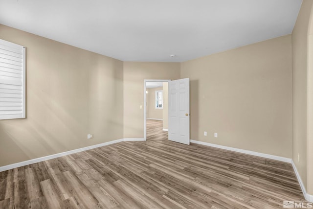 empty room with hardwood / wood-style flooring