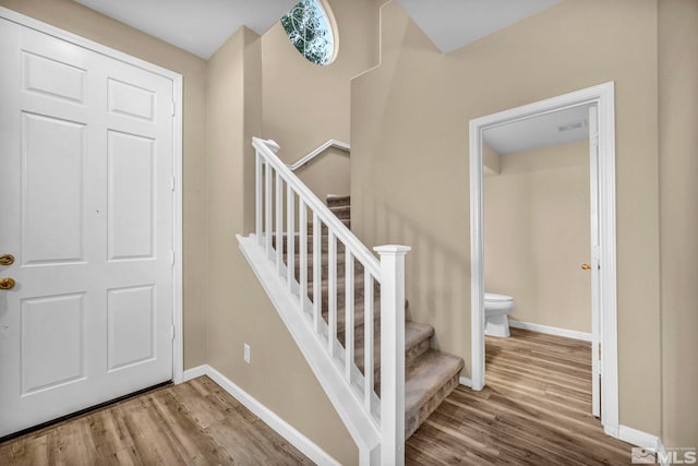 stairs featuring hardwood / wood-style flooring