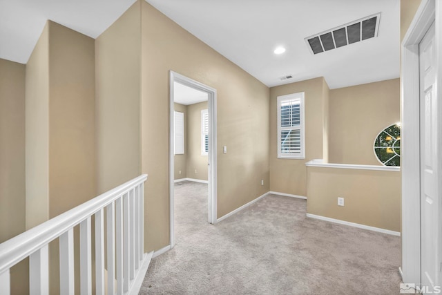 corridor with light colored carpet