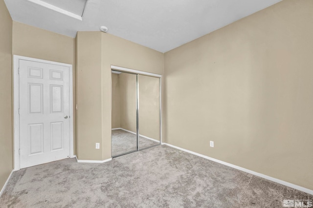 unfurnished bedroom featuring carpet and a closet