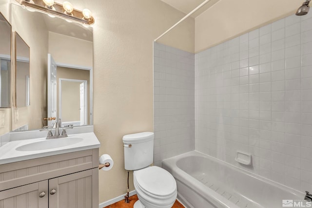 full bathroom featuring tiled shower / bath combo, toilet, and vanity