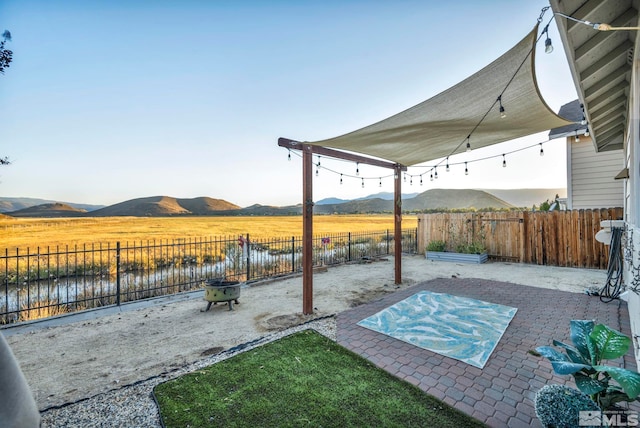 view of patio featuring a mountain view and a rural view