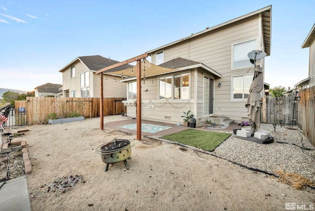 back of house with a patio and a fire pit