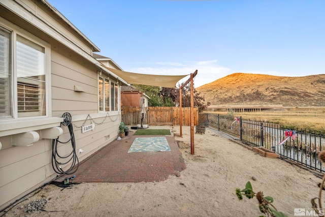 view of yard with a mountain view and a patio