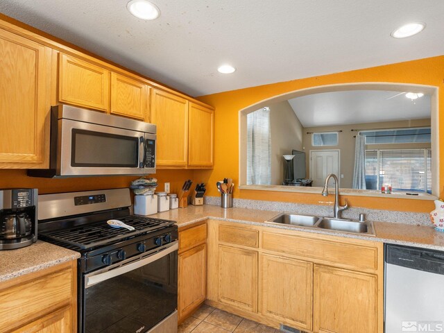 kitchen featuring sink, light tile patterned floors, and stainless steel appliances