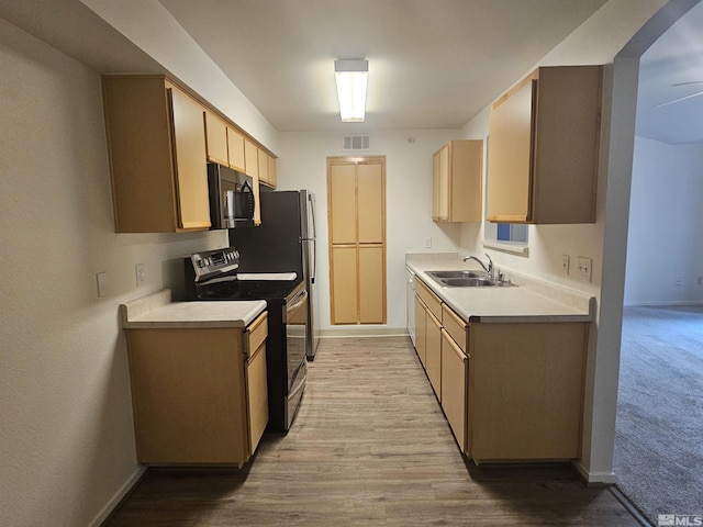 kitchen with ceiling fan, sink, light brown cabinets, light hardwood / wood-style flooring, and stainless steel range with electric cooktop