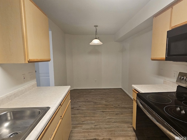 kitchen featuring black range with electric stovetop, sink, dark hardwood / wood-style floors, light brown cabinetry, and decorative light fixtures