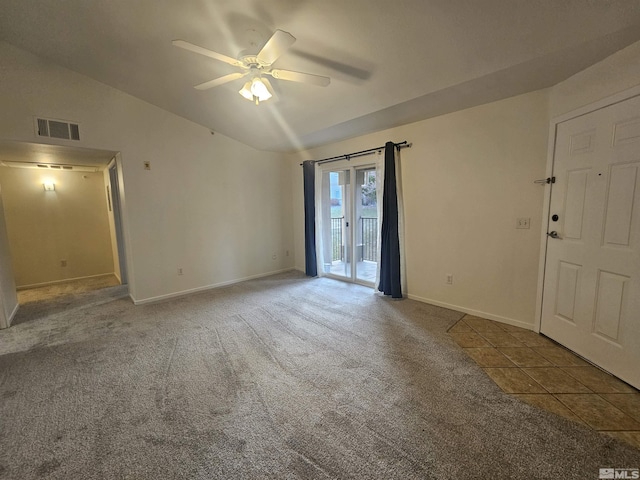 carpeted empty room featuring ceiling fan and vaulted ceiling