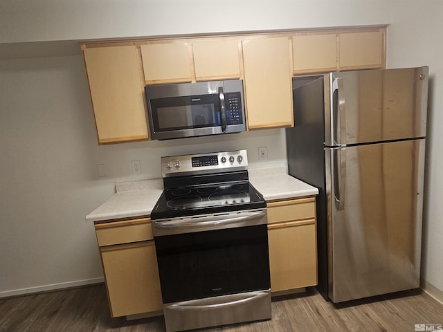 kitchen featuring appliances with stainless steel finishes, light brown cabinets, and light hardwood / wood-style flooring