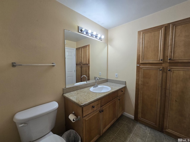 bathroom featuring tile patterned floors, vanity, and toilet