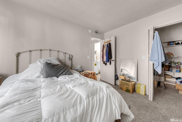 bedroom featuring carpet floors and a textured ceiling