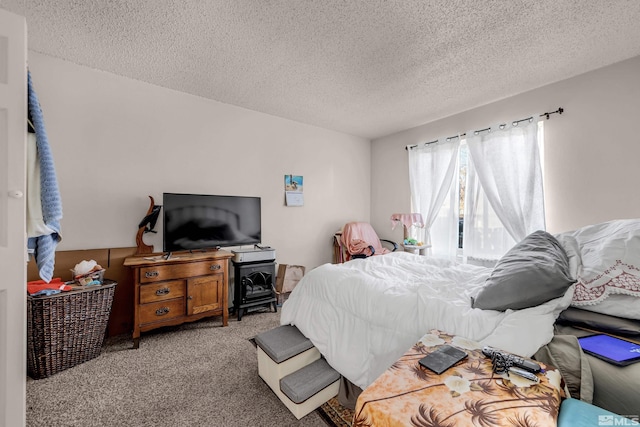 bedroom with light colored carpet and a textured ceiling