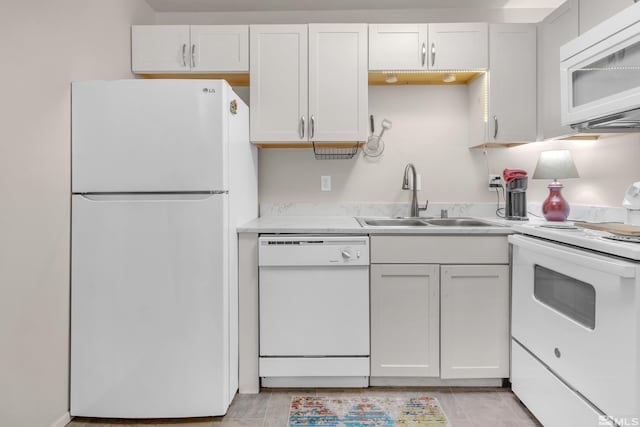 kitchen featuring white cabinetry, white appliances, and sink