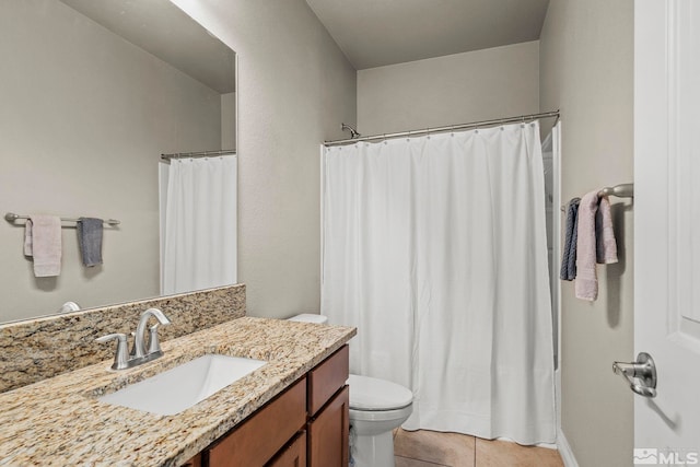 bathroom with tile patterned flooring, vanity, and toilet