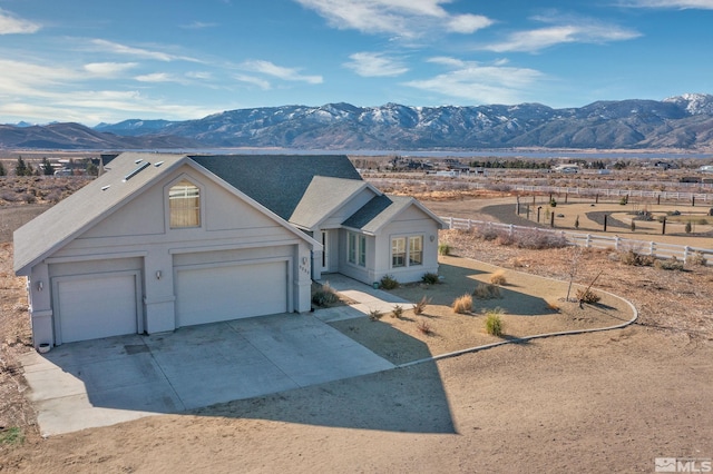 ranch-style house with a mountain view and a garage