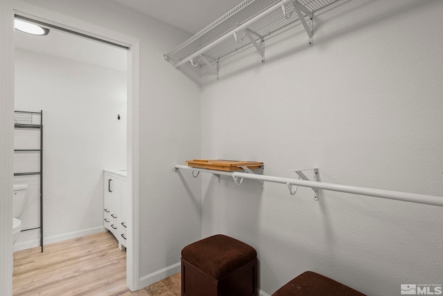 walk in closet featuring light wood-type flooring