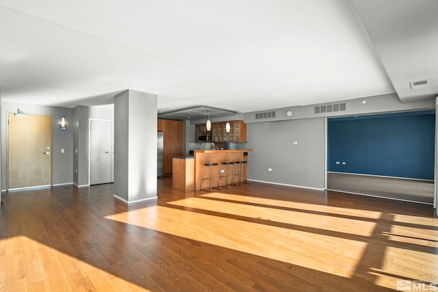 unfurnished living room featuring dark hardwood / wood-style floors