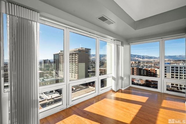 unfurnished sunroom featuring a mountain view