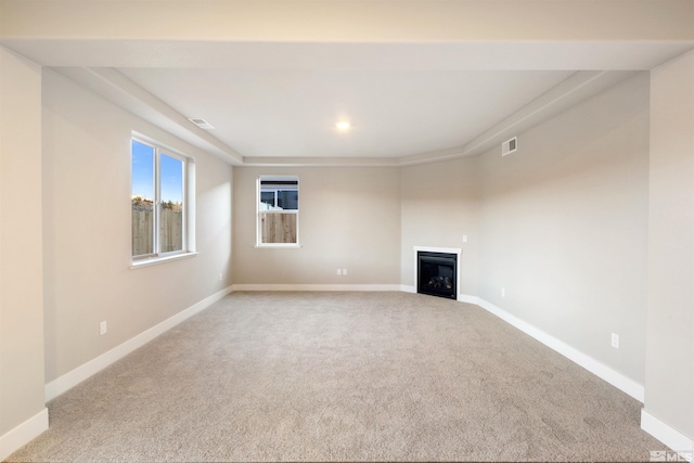 unfurnished living room with light colored carpet