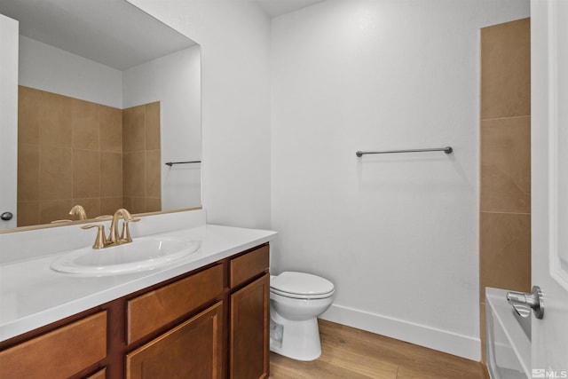 full bath featuring baseboards, vanity, toilet, and wood finished floors