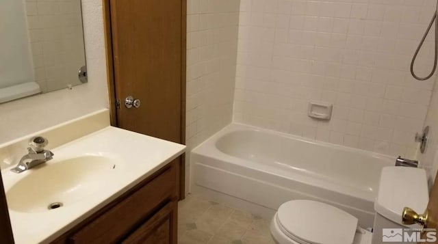 full bathroom with vanity, tile patterned floors, tiled shower / bath combo, and toilet