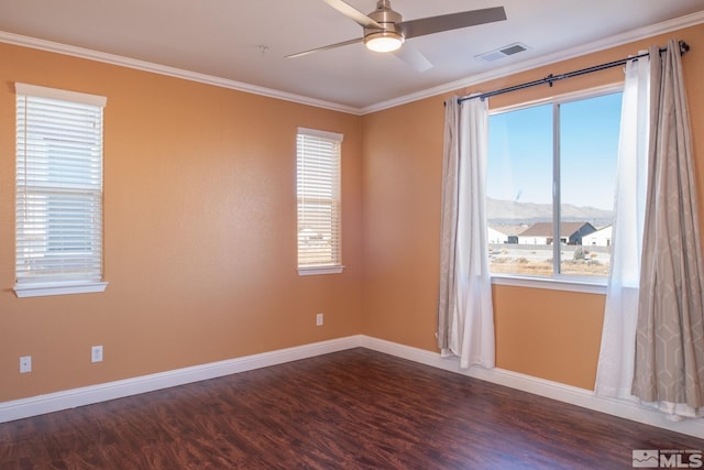 unfurnished room with a mountain view, dark wood-type flooring, and a healthy amount of sunlight