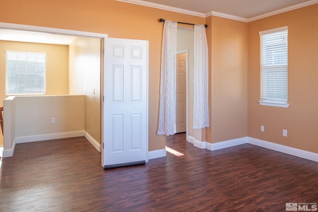 empty room with ornamental molding and dark wood-type flooring