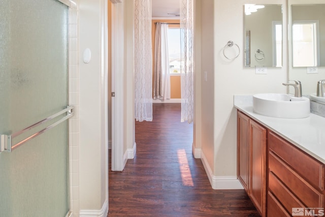 bathroom featuring vanity, hardwood / wood-style flooring, and walk in shower